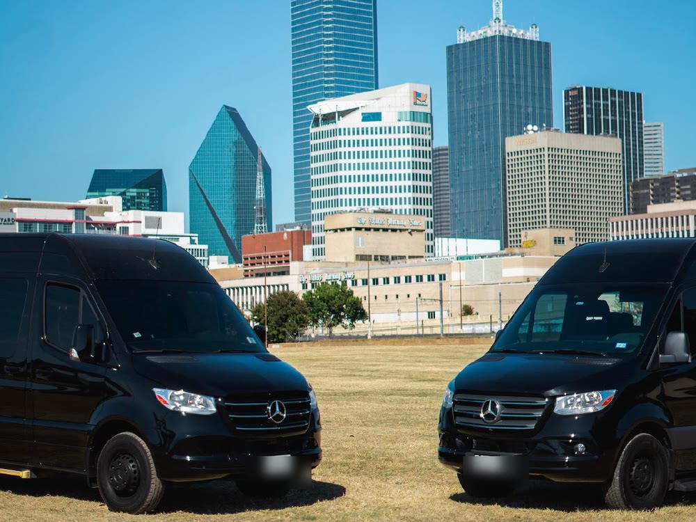 Two JB Luxe Mercedes-Benz Sprinters parked with the Dallas skyline